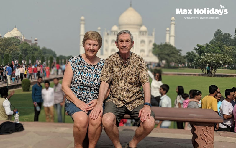 Couple Seating front of Taj Mahal